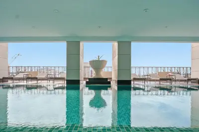 a pool with a fountain in the middle of a building at Admiral Baysuites 2602 in Manila