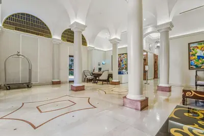 a lobby with columns and a drawing on the floor at Admiral Baysuites 2602 in Manila