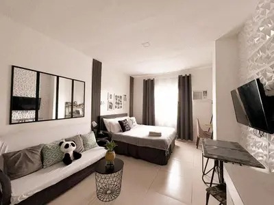 a hotel room with a bed and a couch in it at BES Building in Dasmariñas