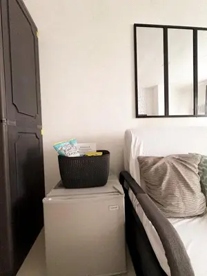 a basket on top of a chest next to a bed at BES Building in Dasmariñas