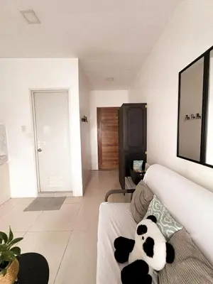 a panda bear laying on a couch in a living room at BES Building in Dasmariñas