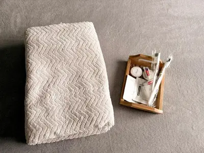 a towel and a box with a clock on the floor at BES Building in Dasmariñas
