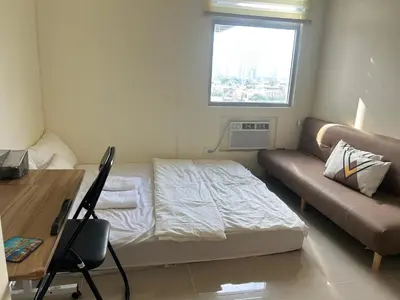 a small room with a bed and a couch at UDCT Condo Hotel in Manila in Manila