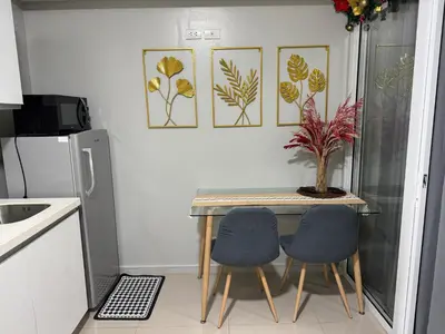 a small kitchen with a table and two chairs at Casa Est Staycation - Azure Urban Resort Residences in Manila