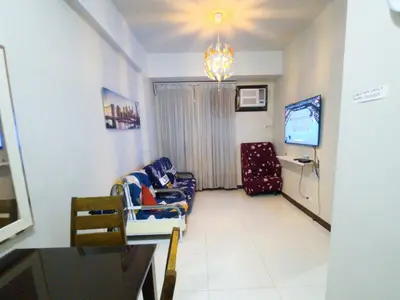a hospital room with a couch and a tv at A&G Condotel Right Across NAIA Terminal 3 in Manila