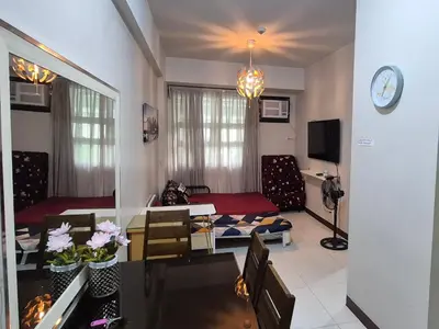 a living room with a couch and a table at A&G Condotel Right Across NAIA Terminal 3 in Manila