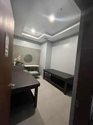a room with a table and a bench in it at Affordable 1BR Condo In Pasay with Balcony and Amenity View, Free Pool Fast WiFi Near NAIA Airport , MOA,PICC in Manila