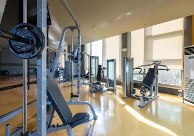 a gym with several tread machines in a room at Affordable 1BR Condo In Pasay with Balcony and Amenity View, Free Pool Fast WiFi Near NAIA Airport , MOA,PICC in Manila