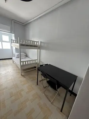 a room with a black table and a bunk bed at Just for sleeps in Manila