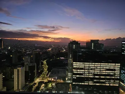 a view of a city skyline at sunset at 35th Prime Staycation BGC in Manila