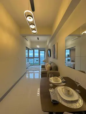 a living room with a table and a couch at 35th Prime Staycation BGC in Manila