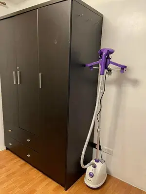 a purple hair dryer in a room next to a locker at Cozy Transient Home Uno in Manila