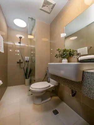 a bathroom with a toilet and a sink at Modern 2-Bedroom BGC Condo by Uptown Mall in Manila