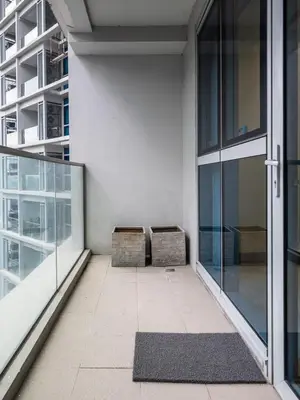 a balcony with two benches in a building at Modern 2-Bedroom BGC Condo by Uptown Mall in Manila