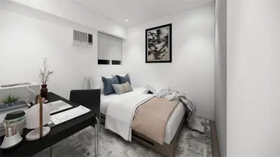 a white bedroom with a bed and a desk at Staycation by Carmen Romualdo in Manila