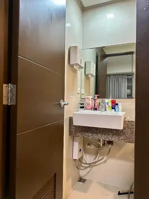 a bathroom with a sink and a mirror at Condotels by ZJM Residence in Manila