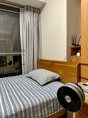 a small bedroom with a bed and a window at Condotels by ZJM Residence in Manila