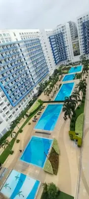 an aerial view of a resort with palm trees and buildings at Sea Residences Pasay City MOA by Jhayem in Manila
