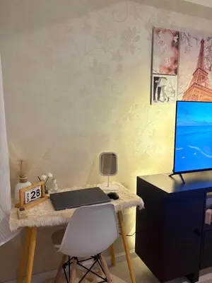a desk with a laptop computer and a chair at Azure Urban Resort Residences in Manila