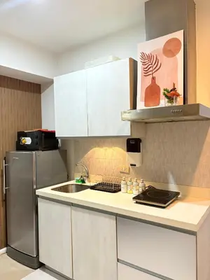 a kitchen with a sink and a refrigerator at Azure Urban Resort Residences in Manila