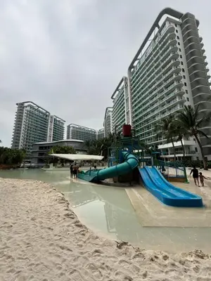 a playground on a beach next to a building at Azure Urban Resort Residences in Manila