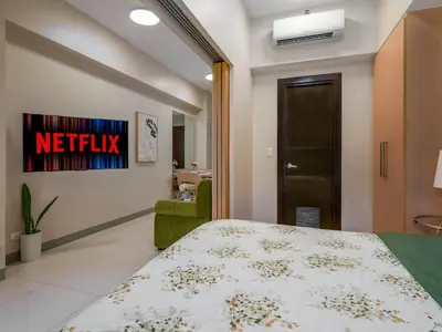 a hospital room with a bed and a chair at Uptown Parksuites Balcony Mall View in Manila