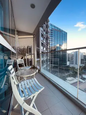 a balcony with a table and chairs on a building at Uptown Parksuites Balcony Mall View in Manila