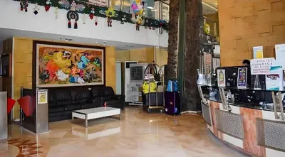a living room with a black couch and a table at Manila bay view condo birch tower in Manila
