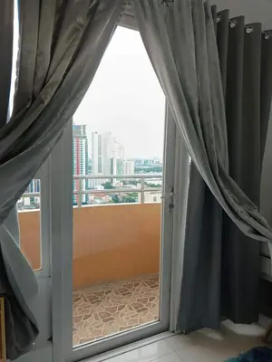 a sliding glass door with a view of a city at Manila bay view condo birch tower in Manila