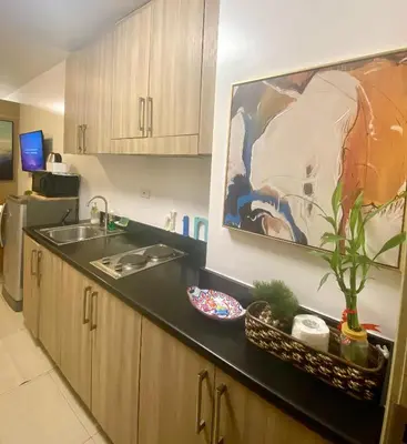 a kitchen with a sink and a counter top at Shore Residences Tower B in Manila