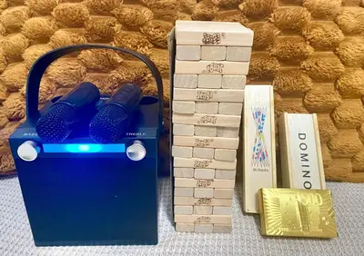 a blue box with two hair dryers in it next to books at Shore Residences Tower B in Manila