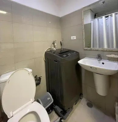 a small bathroom with a toilet and a sink at Shore Residences Tower B in Manila