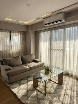 a living room with a couch and a glass table at Exquisite Property Stays at Acacia Estate Taguig City in Manila