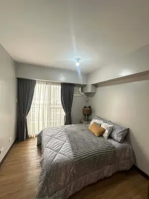 a bedroom with a large bed and a window at Exquisite Property Stays at Acacia Estate Taguig City in Manila