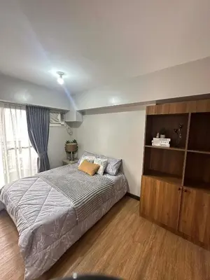 a bedroom with a bed and a book shelf at Exquisite Property Stays at Acacia Estate Taguig City in Manila