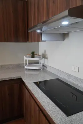 a kitchen with a counter top with a sink at Exquisite Property Stays at Acacia Estate Taguig City in Manila