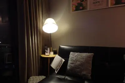 a room with a couch and a lamp and a table at The Cube at 15th in Taytay