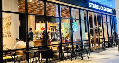 a group of people standing outside of a restaurant at D'Gonia Space in Manila