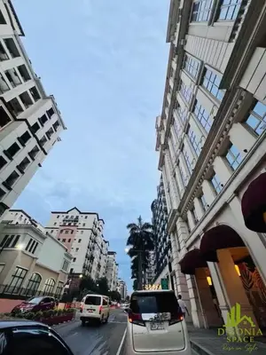 a city street with cars driving down a street with tall buildings at D'Gonia Space in Manila