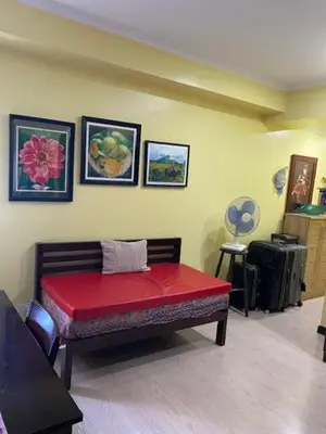 a room with a bench with a red cushion at South of Market Private Risidence in Manila