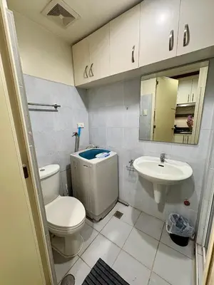 a bathroom with a toilet and a sink at Melas Condotel in Manila