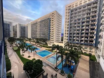 an aerial view of a resort with a pool and buildings at Melas Condotel in Manila