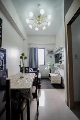 a dining room with a table and a living room at R and K staycation in Manila