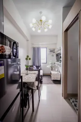 a kitchen and living room with a table and a dining room at R and K staycation in Manila
