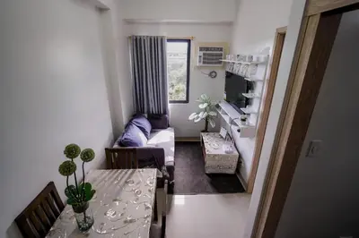 a living room with a table and a couch at R and K staycation in Manila