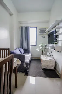a living room with a couch and a table at R and K staycation in Manila