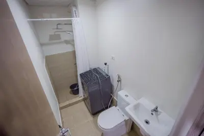 a small bathroom with a toilet and a sink at R and K staycation in Manila