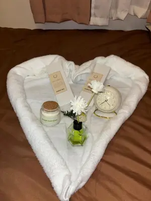 a heart shaped towel with a clock and flowers on it at Cozy Staycation in Cubao with Netflix in Manila