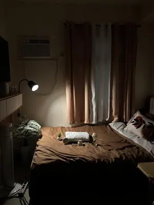 a bedroom with a bed with a stuffed animal on it at Cozy Staycation in Cubao with Netflix in Manila