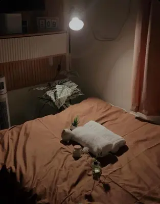 a bed with a towel on top of it at Cozy Staycation in Cubao with Netflix in Manila